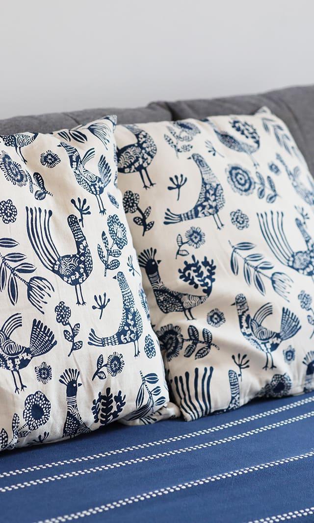 Blue bird-print cushions on a guest sofa