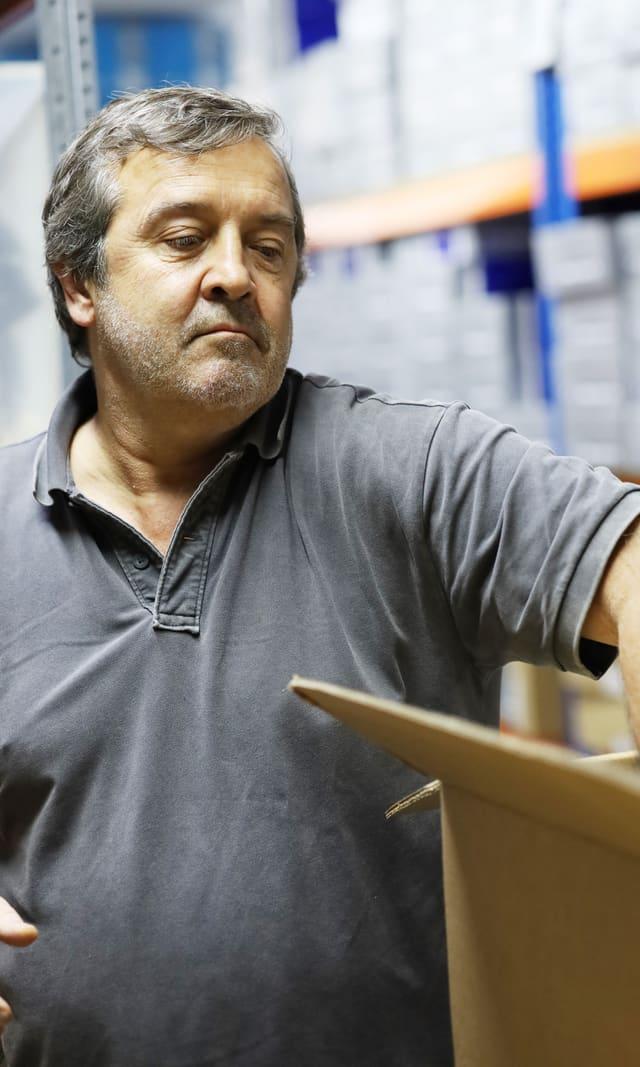 Manager checking a box in the JET warehouse