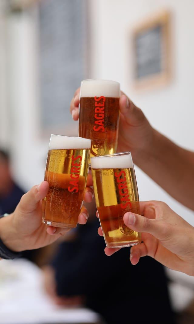 Beer glasses raised in a toast at the table