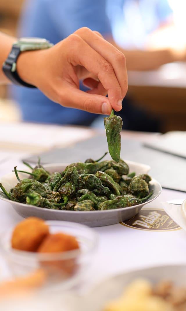 Padrón peppers being served at the table