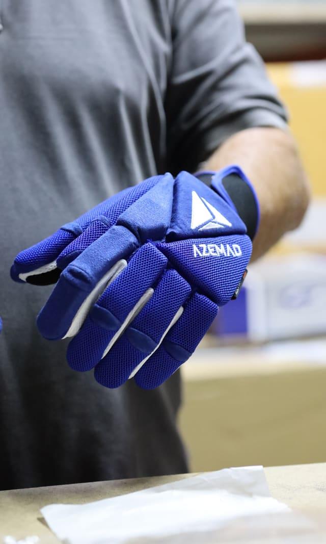 Blue goalkeeper gloves on an athlete's hands