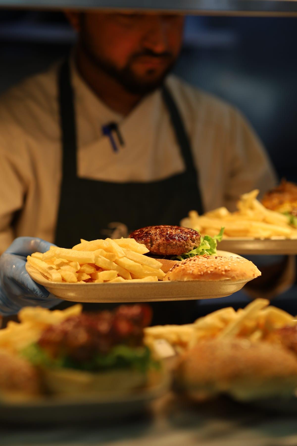 Burger with fries served at the table